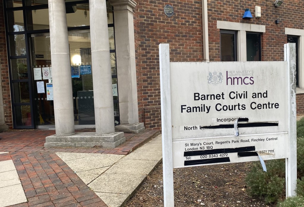 A sign outside the court.  It is filthy and has gaffer tape covering up redundant words